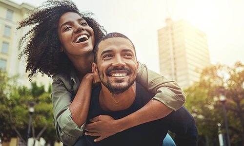 woman on mans back laughing