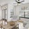 Spacious and well lit living room with wood floors and an open floor plan with access to the kitchen.